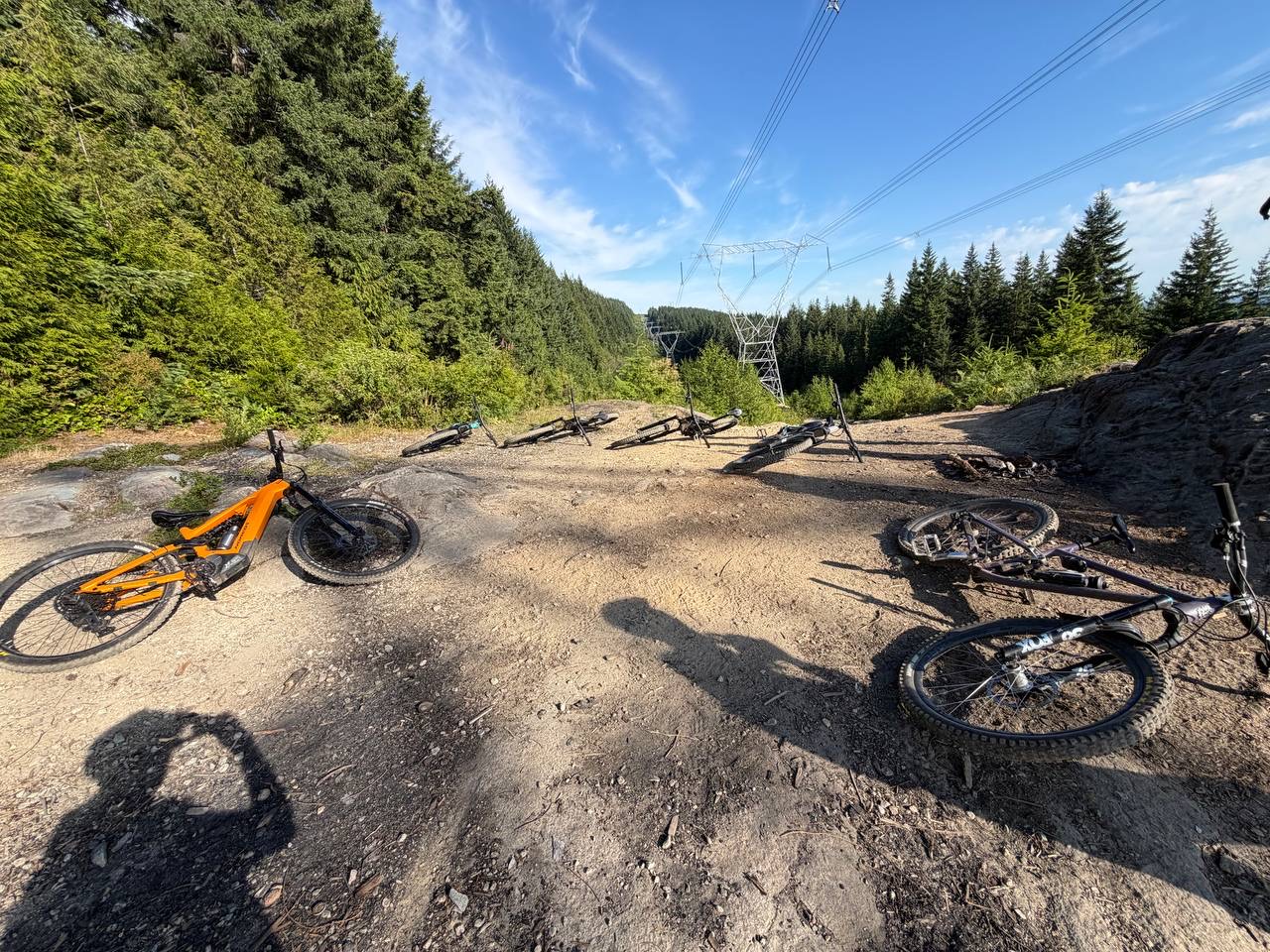 Eagle Bluff trail approach with forest, rocky ground, bikes, and power line corridor